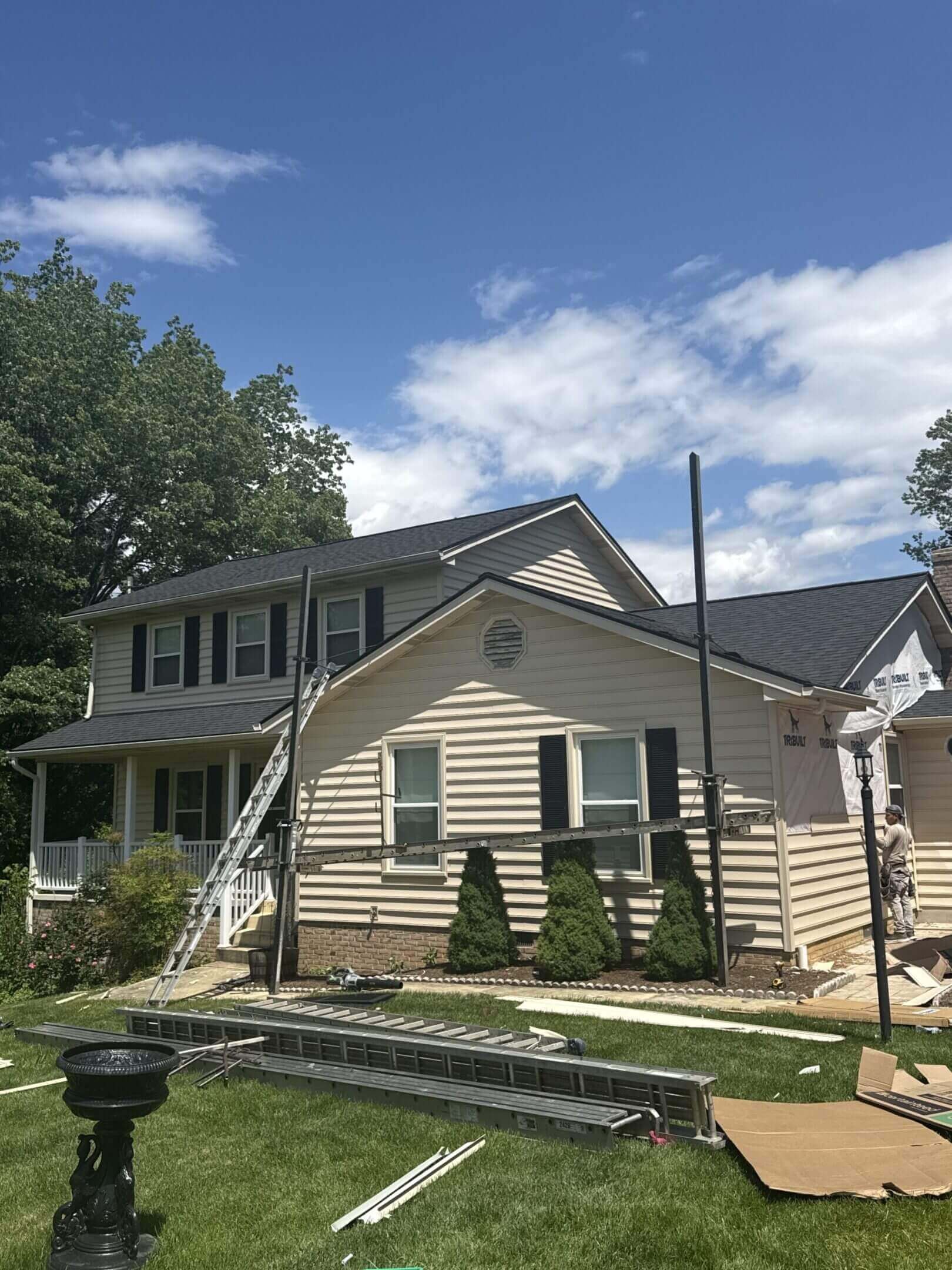 House under renovation with construction materials outside.